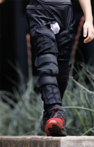 The MyoStep soft exoskelton on the legs of a child who is walking toward the camera.