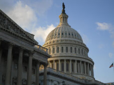Capitol dome against blue sky with white clouds
