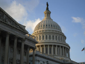 Capitol dome against blue sky with white clouds