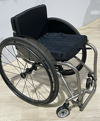 Three-quarters/overhead view of TiLite TR dual-tube ultralightweight chair with a silver frame.